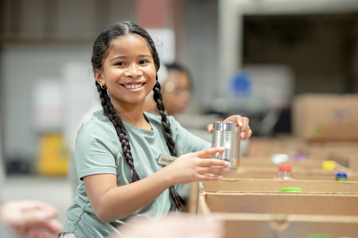 Young Girl Helping Pack at a Food Bank