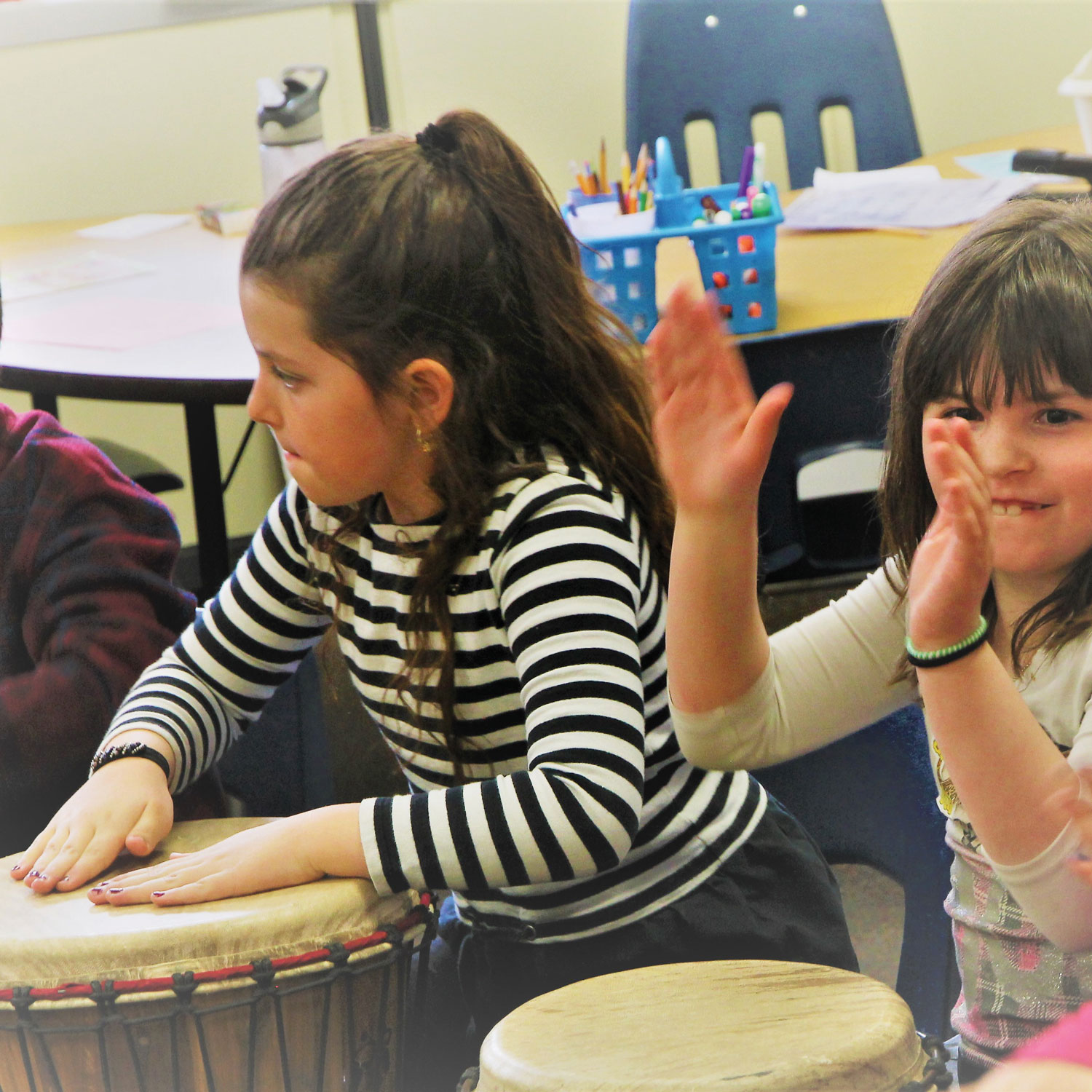 Russell Elementary first graders drumming with the Drum Brothers